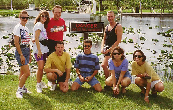 group of young people in shorts and t shirts smiling for the camera