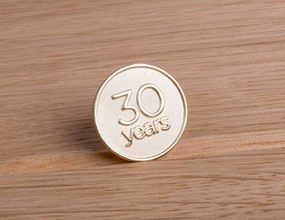 gold lapel pin commemorating 30 years of service