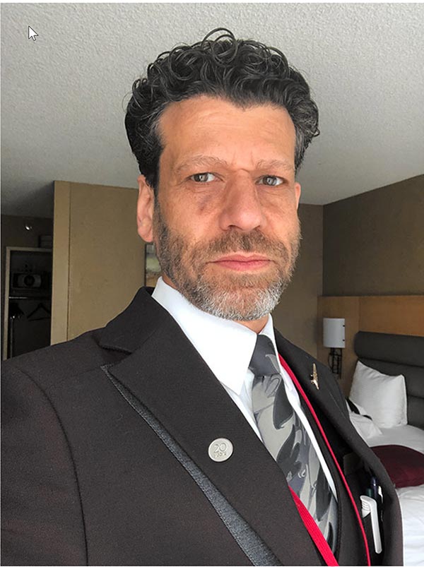 selfie of a male flight attendant in uniform