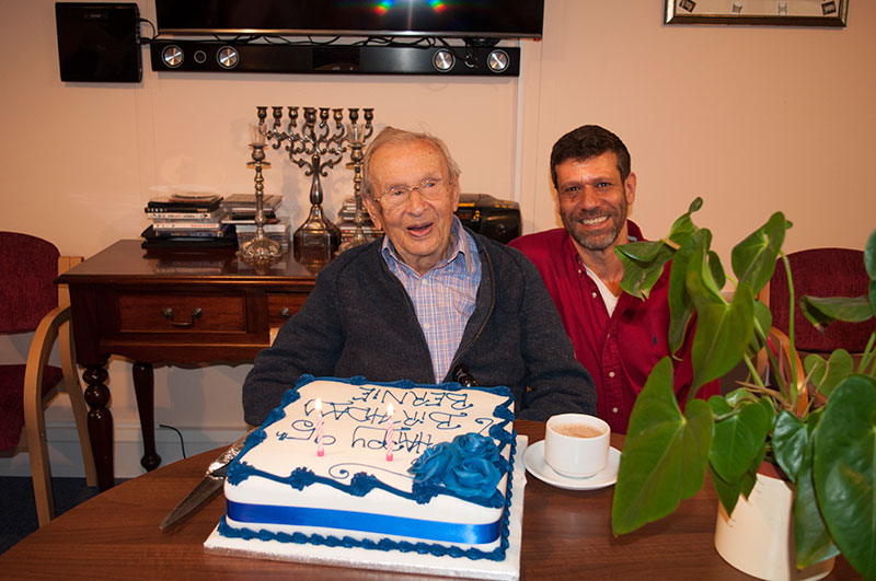 father and son and a big birthday cake