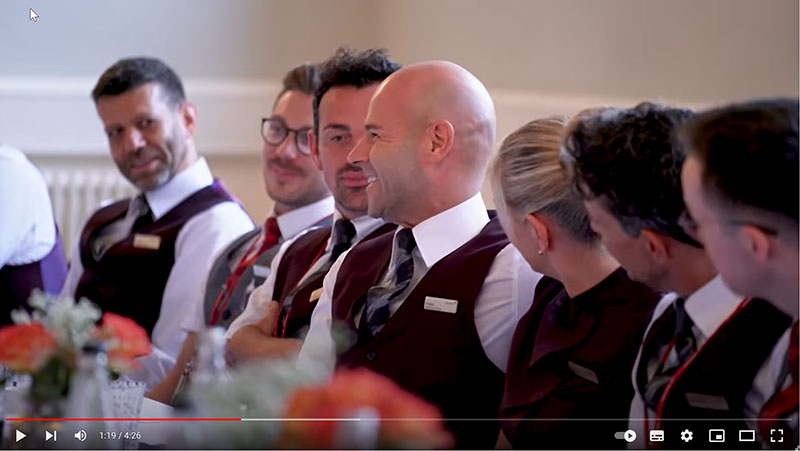 virgin atlantic onboard managers listening to one of the group speaking